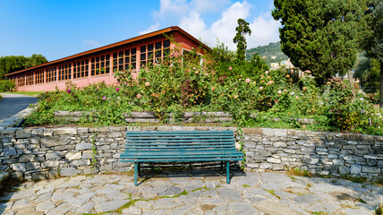 Genoa, Italy. Empty bench in a rose garden in the Nervi Park garden, on a warm and sunny October day.