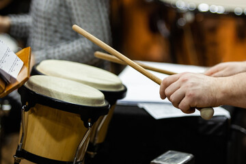 Hands of a musician playing a drum kit close-up