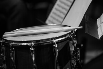 Drumsticks lying on a drum in black and white - 733001417