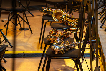  Saxophones lying on chairs on stage - 733001455