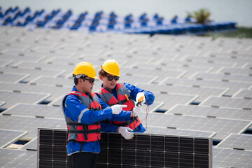 Photovoltaic engineers work on floating photovoltaics. Inspect and repair the solar panel equipment...