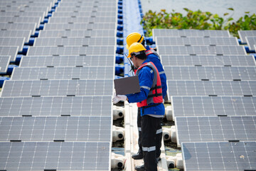 Photovoltaic engineers work on floating photovoltaics. Inspect and repair the solar panel equipment floating on the water.