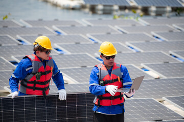 Photovoltaic engineers work on floating photovoltaics. Inspect and repair the solar panel equipment...