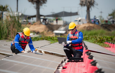 Photovoltaic engineers work on floating photovoltaics. Inspect and repair the solar panel equipment floating on the water.