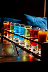 Variation of hard alcoholic shots served on bar counter.