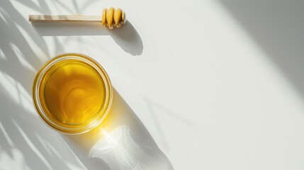 Glass jar full of honey and wooden stick on a white background.