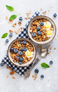Homemade granola with ripe blueberries, top down view