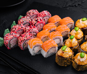 Sushi set on black slate top view