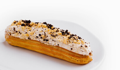 Eclair with cream and chocolate on plate