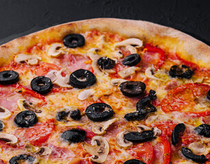 Pizza with tomato, olives, champignons, ham and cheese