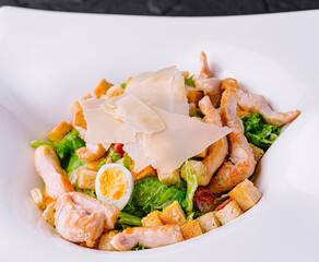 Caesar salad with grilled chicken meat, fresh lettuce, parmesan cheese and fried croutons