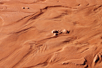 Fototapeta na wymiar Red earth, dark red sand texture on the ground