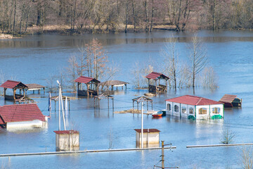flooded buildings on the river bank during the spring flood. top view