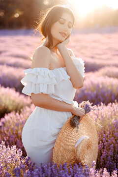 Portrait of a girl in lavender field holding violet lavender flowers