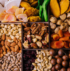Assorted nuts and dried tropical fruits in a wooden box