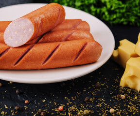 boiled sausages with cheese on plate