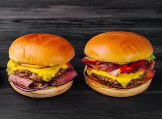 Tasty burgers on wooden table top view