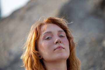 An enchanting portrait of a young freckled red-haired woman