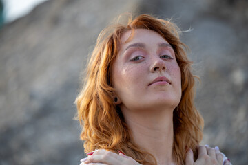 An enchanting portrait of a young freckled red-haired woman