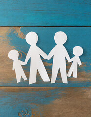 Family paper cut-out figures holding hands