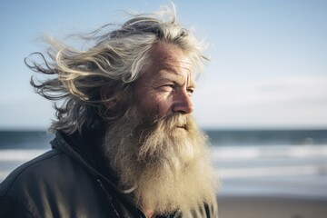 A photograph of a man with long white hair and a beard, staring directly at the camera.