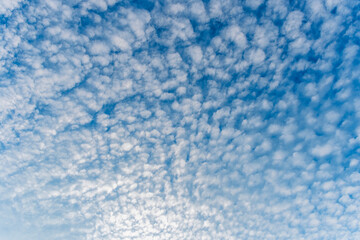 cloudy sky background for wallpaper and design, day skyscape with white beautiful clouds and blue...
