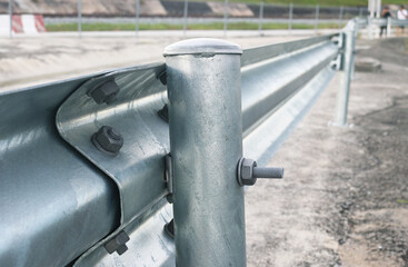 Close-up galvanized steel w-beam guardrail.