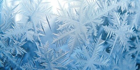 A close-up of a frosted window pane showing intricate ice crystals and patterns, ideal for seasonal decoration themes, weather-related educational content, or abstract backgrounds.
