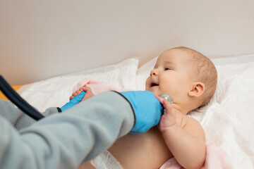 Examining baby using a stethoscope. 