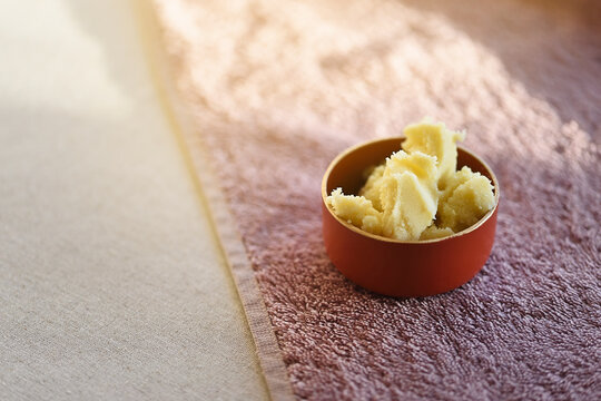 Extraordinary cellular regenerator of pure shea butter in pieces, natural cosmetic concept.