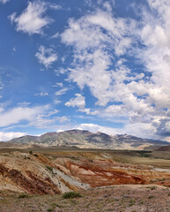 Fototapeta premium brown and red mountains under fine clouds