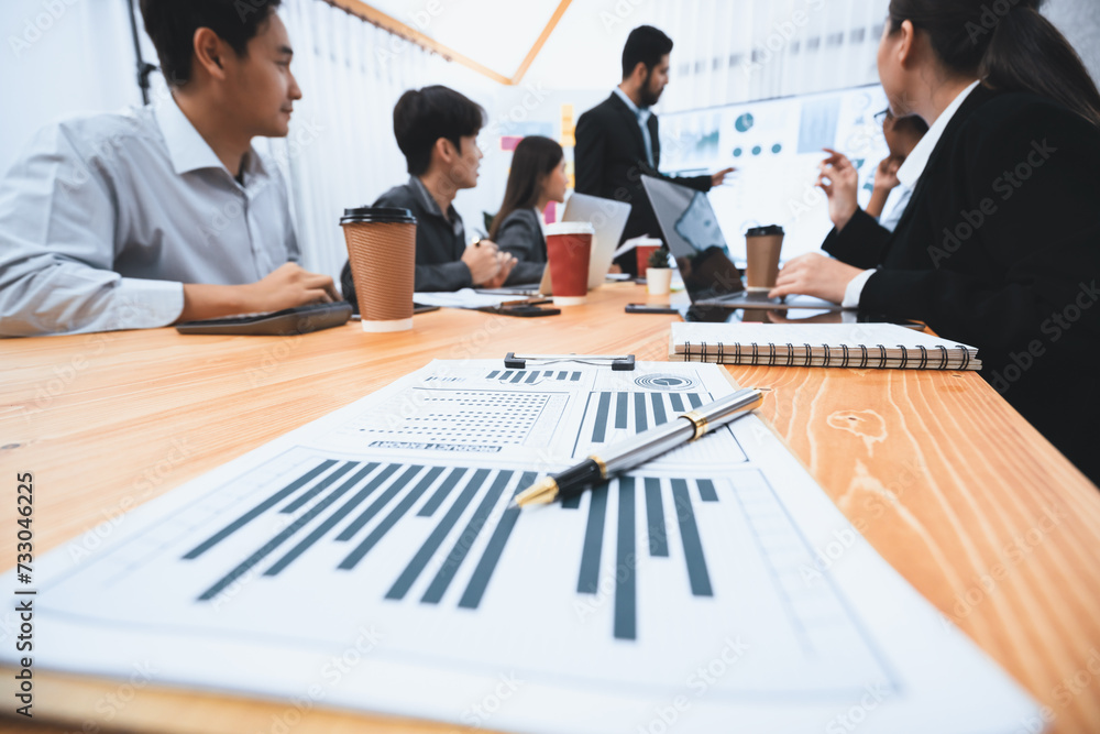 Poster focus financial dashboard paper showing graphs and chart with blurred background of diverse business