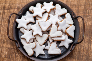 Cinnamon cookies for Christmas, in the shape of hearts and stars