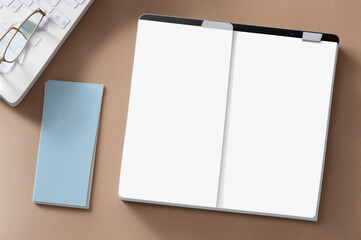Blank white paper with eyeglasses on a wooden table.