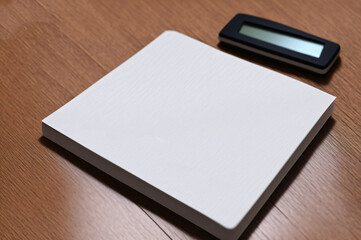 Blank business cards with calculator and pen on the wooden table.