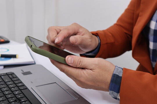 Close up of male hand working with business and forex chart of downward trend and financial downfall concept.