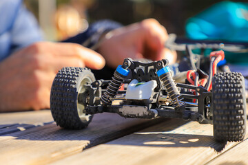 Child playing with a remote-controlled gas-powered toy car