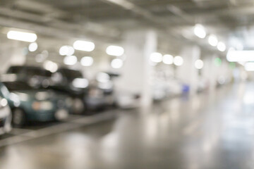 Blurred image of many cars parked in the parking lot under the building to go shopping in the mall...
