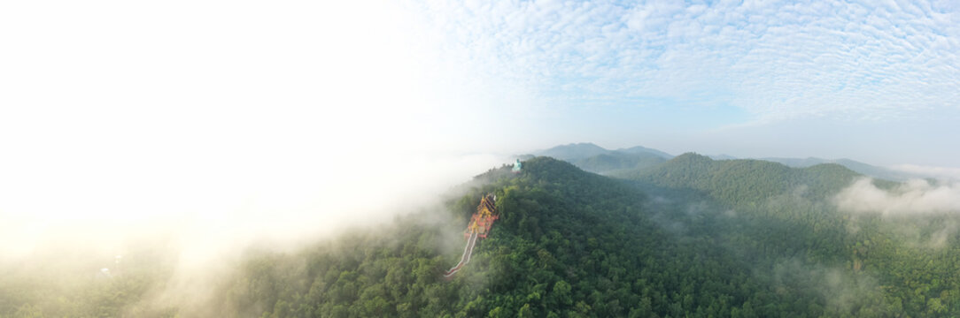 Aerial view of  Wat Pra That Doi Pra Chan and Great Buddha at Doi Phra Chan is a towering bronze Buddha statue that can be reached by climbing 628 steps up, Pa Tan, Mae Tha District, Lampang, Thailand