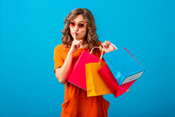 attractive happy smiling stylish woman holding shopping bags