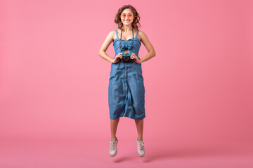 attractive smiling happy woman posing with vintage photo camera