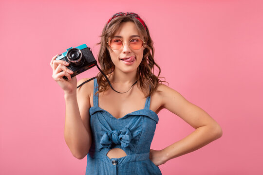 attractive smiling happy woman posing with vintage photo camera