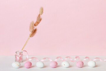 Easter minimalist concept with easter eggs bouquet of dried flowers. Delicate pastel empty background with copy space.	
