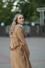 A beautiful young girl walks through the spring city.