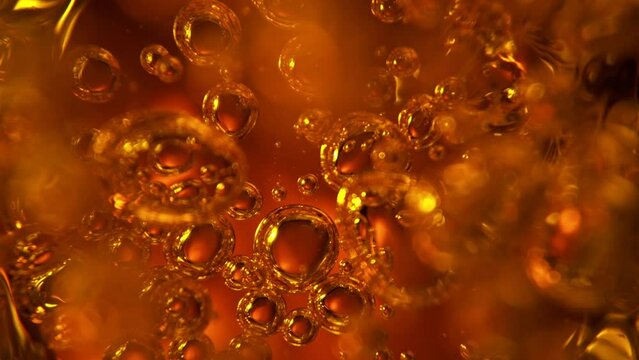 Super Slow Motion of Bubbling Golden Liquid in Detail. Extreme Macro Shot, Abstract Texture. Filmed on High Speed Cinema Camera, 1000 fps.