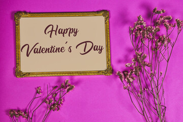 happy valentine's day on golden picture or photo frame mockup with pink baby's breath, gypsophila...
