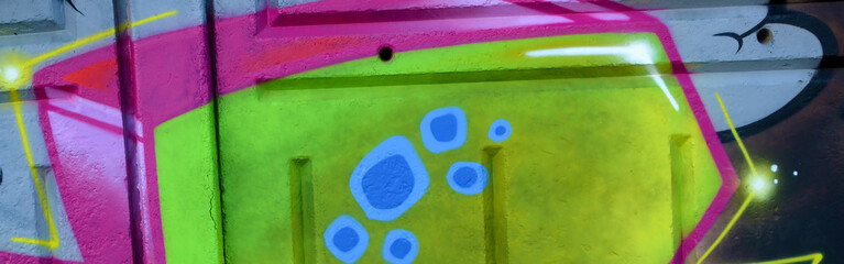 Colorful background of graffiti painting artwork with bright aerosol outlines on wall. Old school...