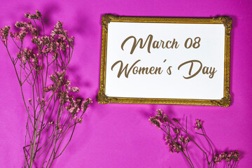 happy women's day on golden picture or photo frame mockup with pink baby's breath, gypsophila on...