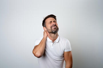 Man pretending to have neck pain - obrazy, fototapety, plakaty