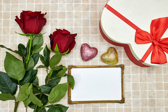 golden picture or photo frame mockup with roses flowers and gift heart shaped box for valentine's day